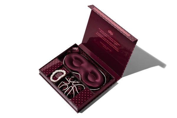 An open lottie gift set box on a white background, containing a matching contour sleep mask and large scrunchie as well as a white skinny scrunchie.