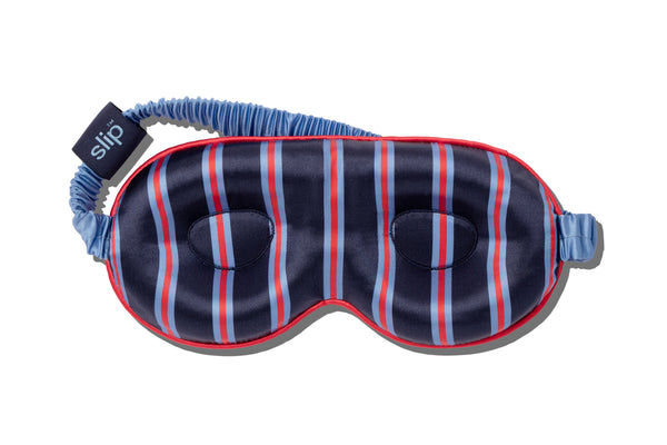 Striped silk contour sleep mask with blue and red pattern on a white background