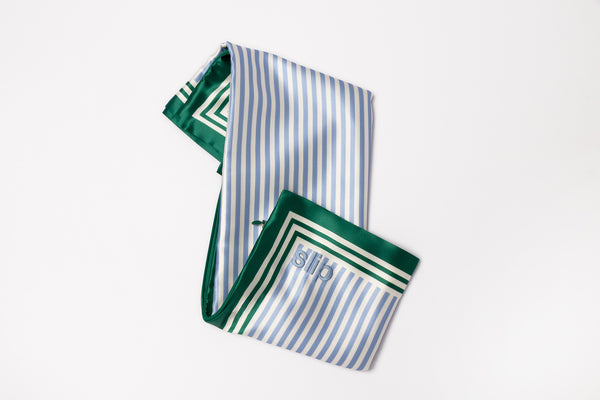 Green and white striped fabric with slip logo embroidered on a white background