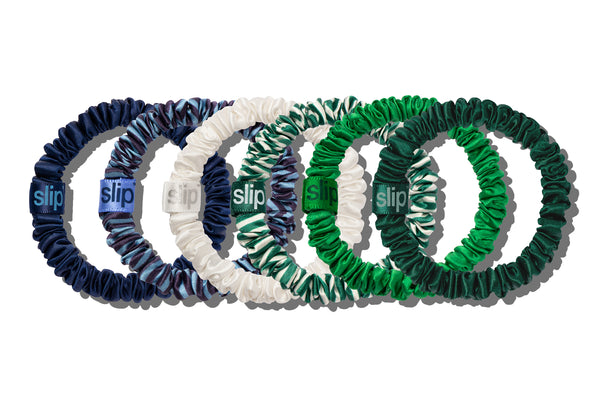 Set of five silk skinny scrunchies in blue, white, and green on a white background with 'slip' branding.