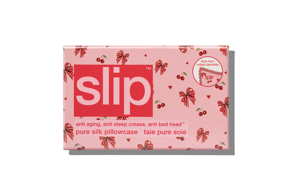 A pink Slip brand pillowcase box with a red bow and cherry pattern, shown on a clean white background with a soft shadow.