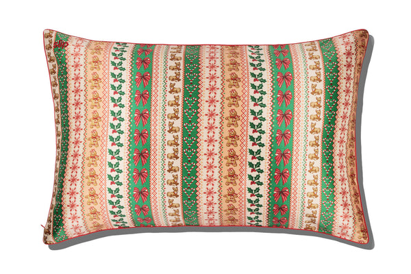A slip silk pillowcase with a festive vertical striped pattern featuring green, red, and beige holiday motifs, shown on a white background with a soft drop shadow.