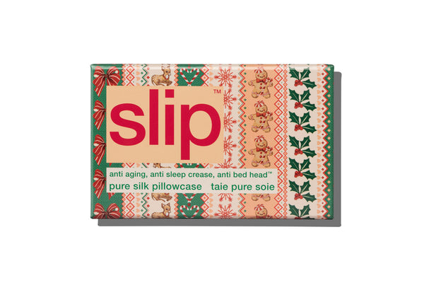 A Slip brand silk pillowcase box, featuring a festive Christmas-themed pattern with green holly, red ornaments, and beige teddy bears on a white background.