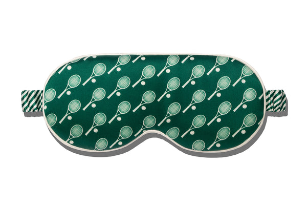 Green silk contour sleep mask with tennis racket pattern on a white background